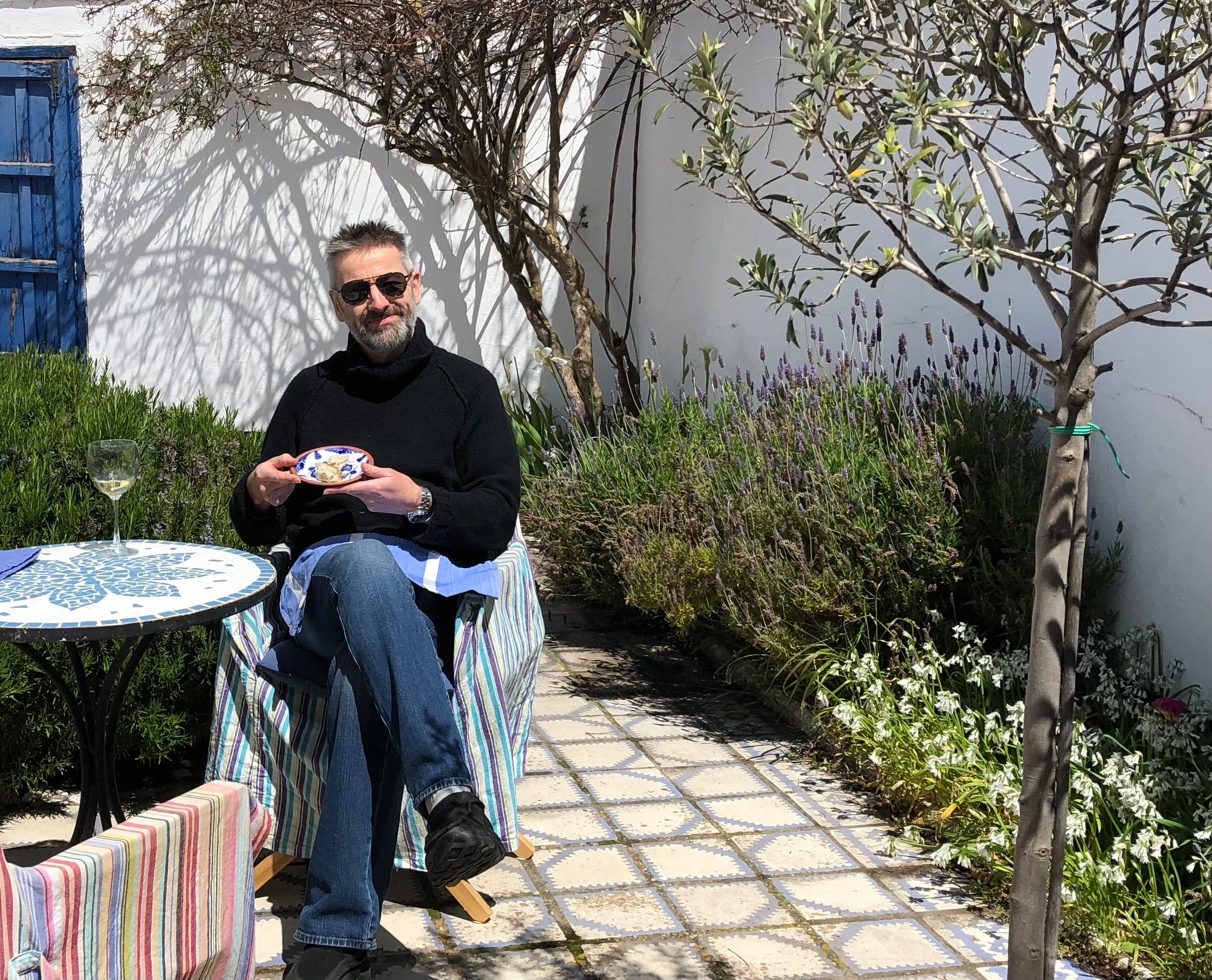 Mark enjoys a drink in his former garden in Comares