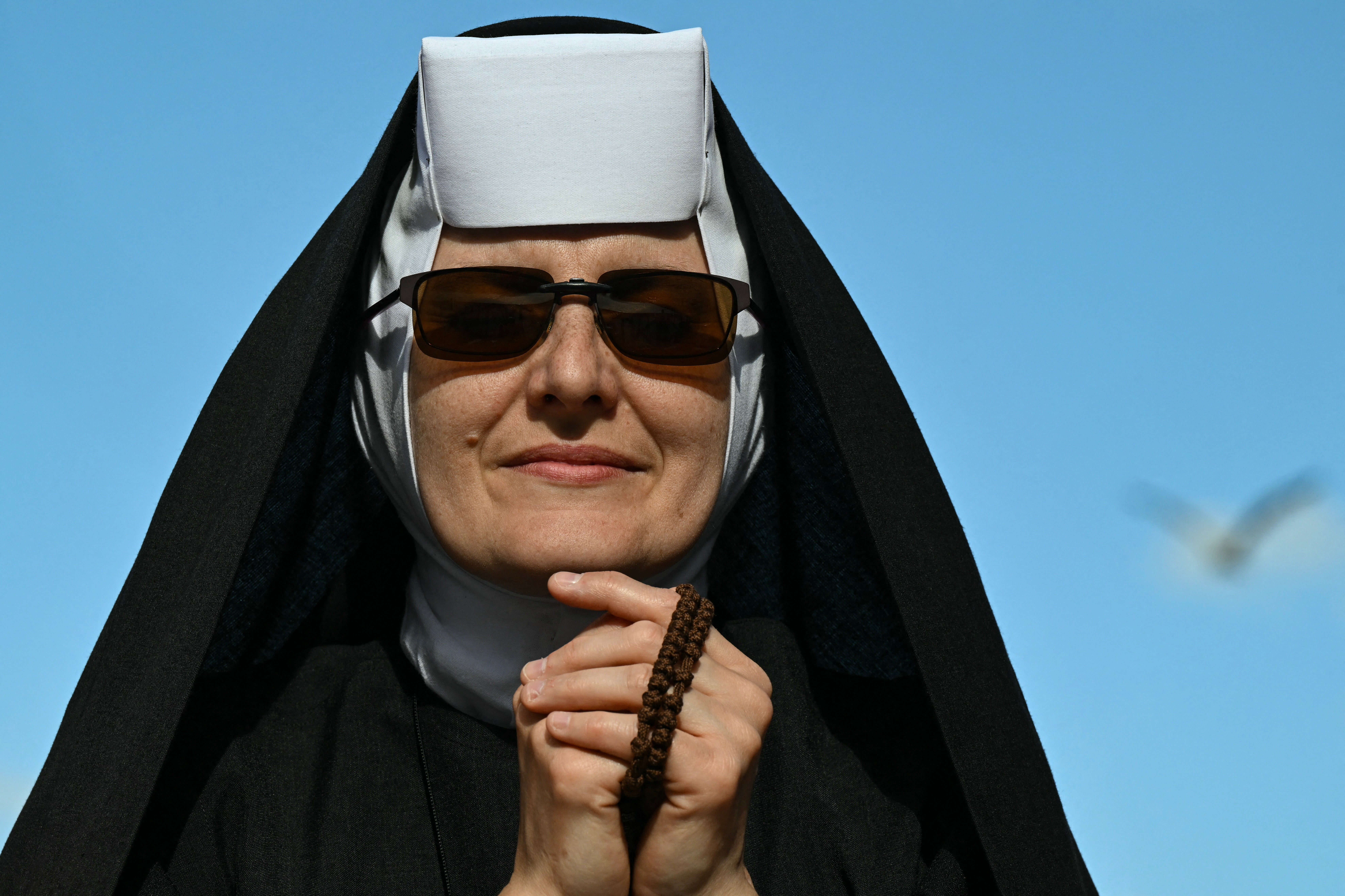 A nun prays on St Peter's Square ahead of the conclave to elect the next pope