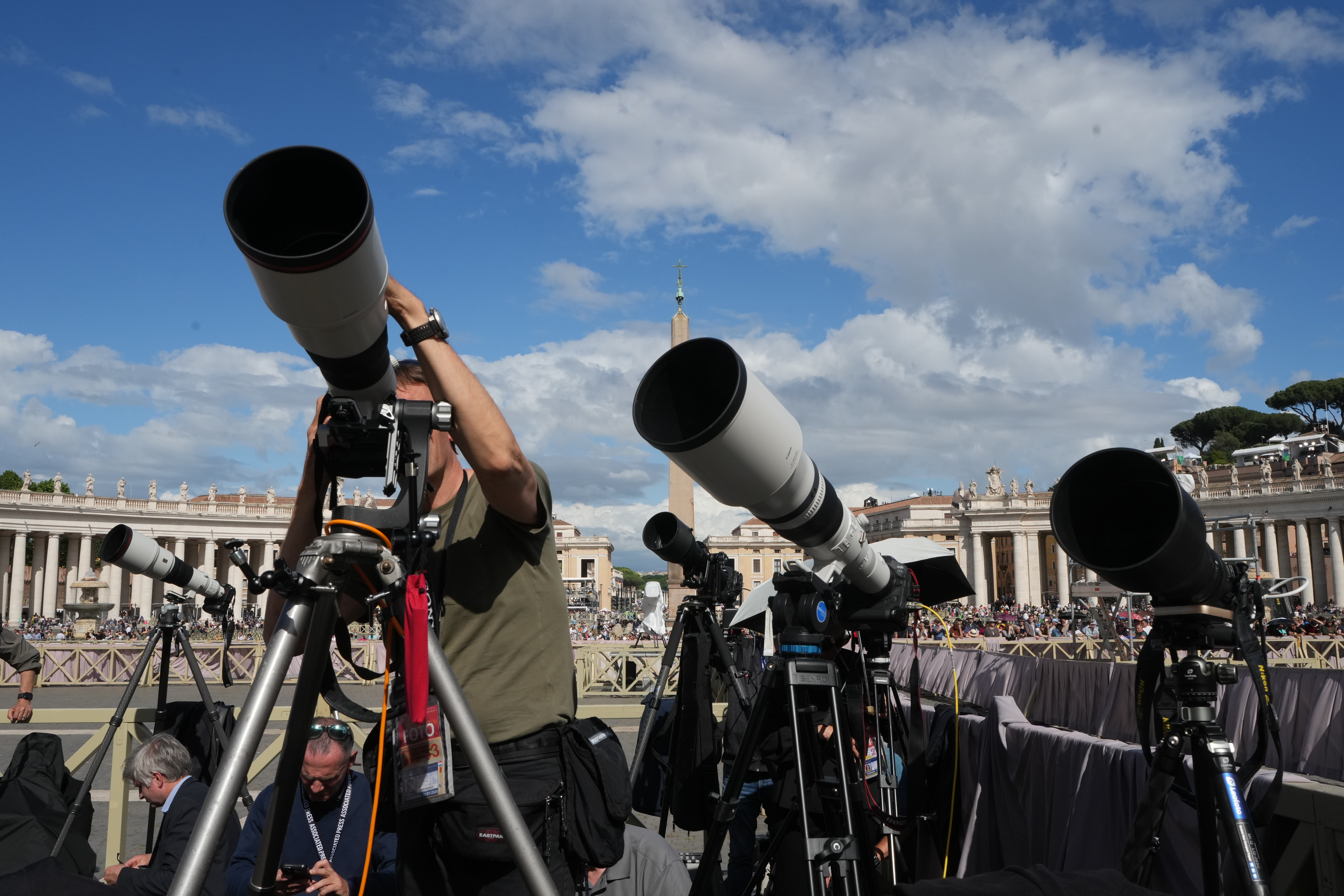 Photojournalists train their telephoto lenses on the chimney of the Sistine chapel