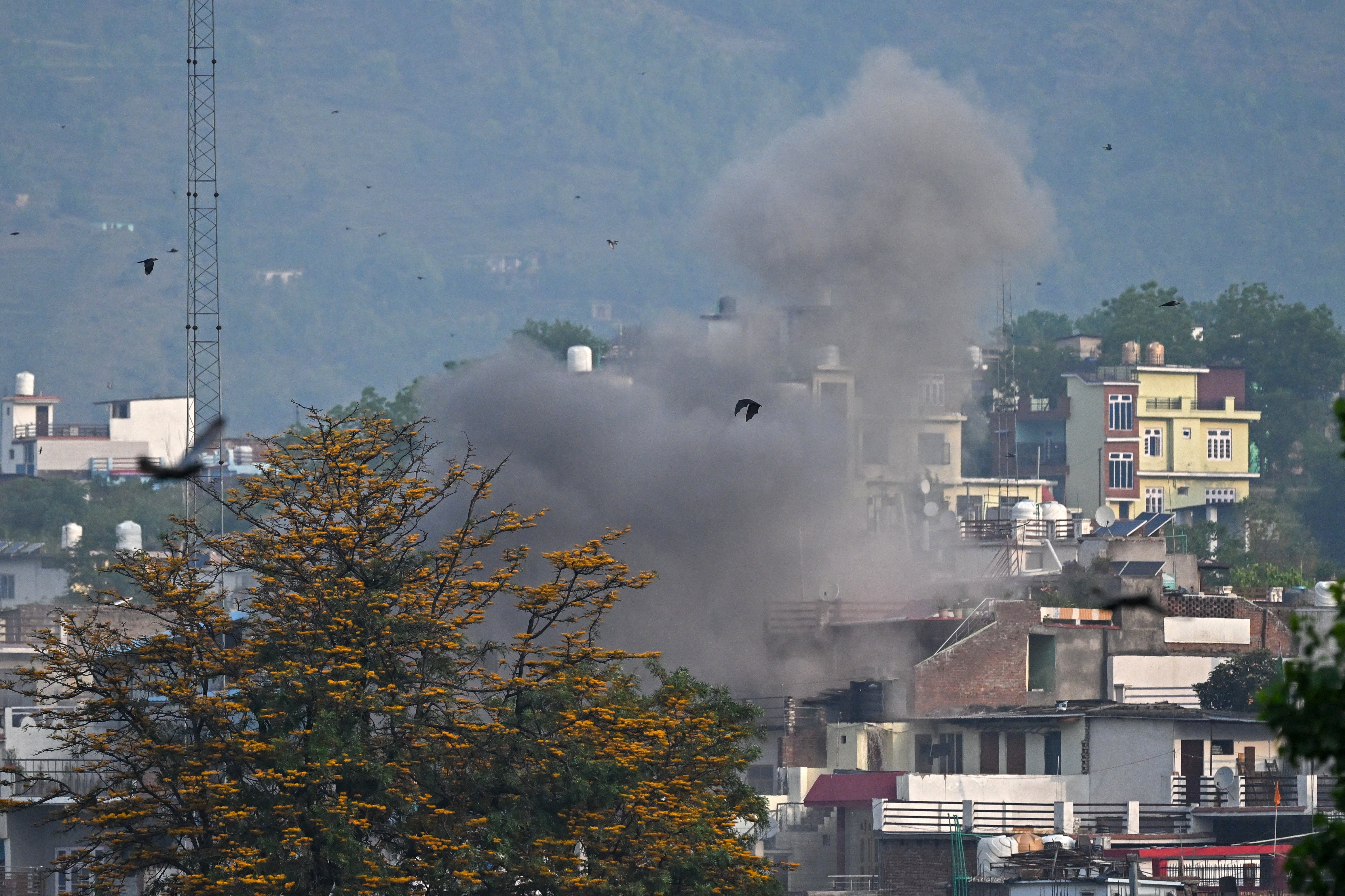 Smoke billows after an artillery shell lands in Poonch town of Jammu and Kashmir on 7 May 2025