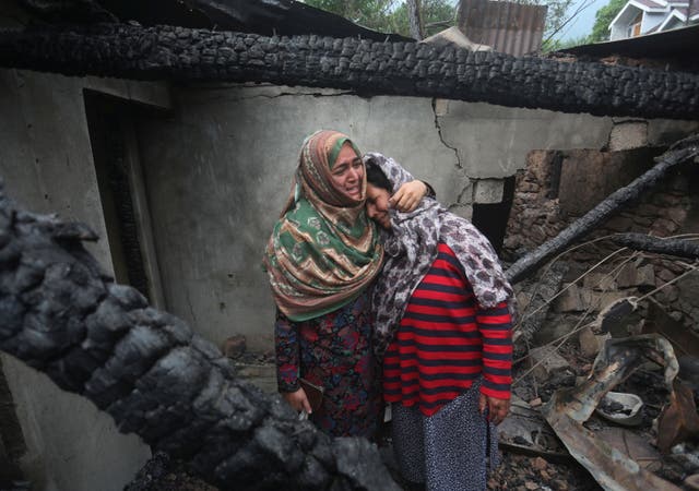 <p>Kashmiri women grieve inside their house damaged after cross-border shelling from Pakistan, at Salamabad village in Uri, north of Srinagar, the summer capital of Indian Kashmi</p>