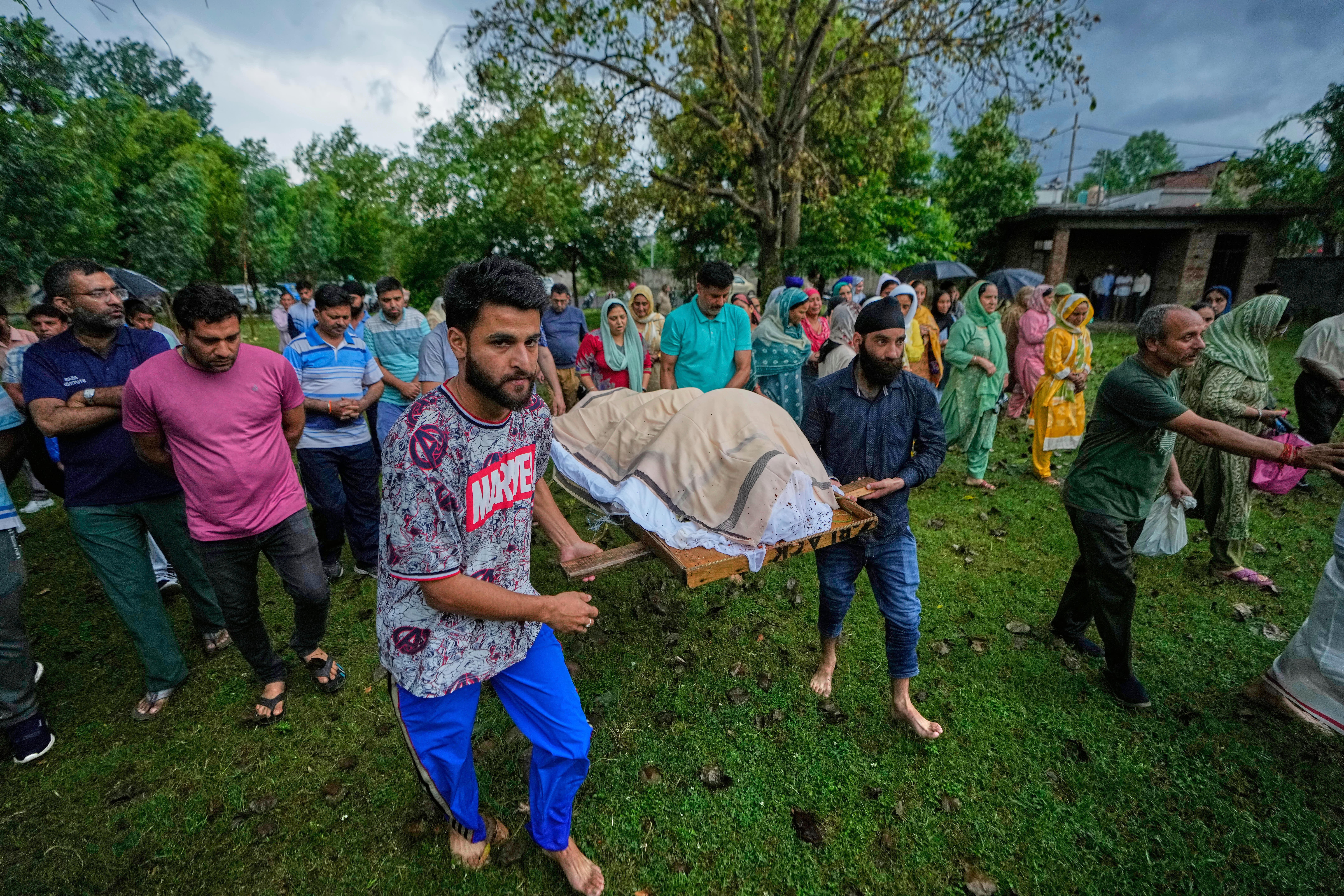 Relatives and friends carry the body of Vihaan Barghava, 13, killed in Pakistani artillery shelling for cremation in Poonch, along the Line of Control