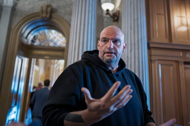 <p>Sen. John Fetterman talks to reporters outside the chamber during a vote at the Capitol in Washington, in March</p>