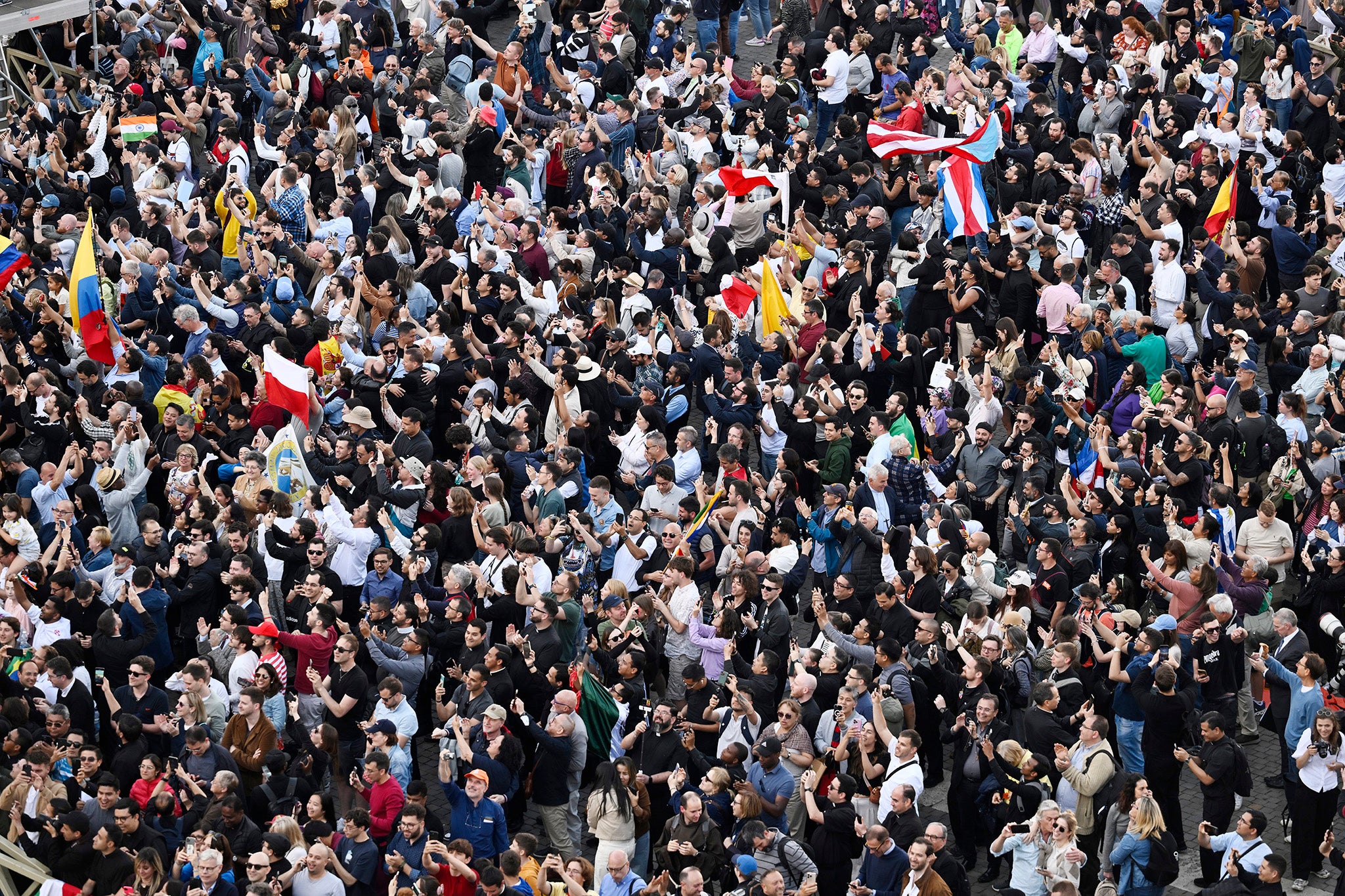 Large crowds celebrate on St Peter's Square as they witness white smoke after a new pope is elected