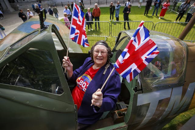 Annie Cherry sits in the Ulster Aviation Society’s replica Spitfire at Belfast City Hall to celebrate the 80th anniversary of VE Day (Liam McBurney/PA)