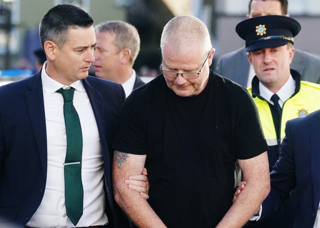<p>Richard Satchwell (centre) arriving at the District Court in Cashel, Co Tipperary, after being charged in connection with the murder of his wife Tina Satchwell</p>
