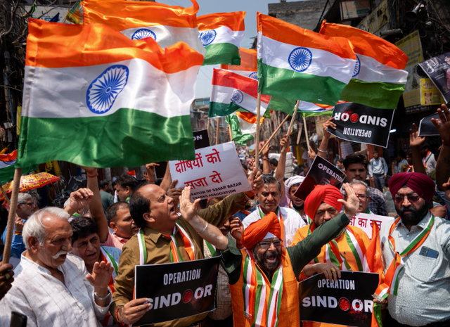 <p>People wave Indian flags and display banners reading ‘Operation Sindoor’ during a protest against Pakistan in New Delhi on 8 May 2025</p>
