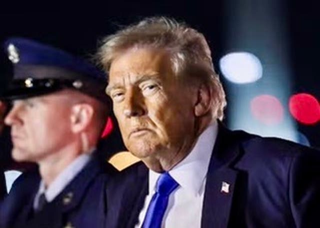 <p>President Donald Trump looks on after disembarking from Air Force One at Palm Beach International Airport last week</p>