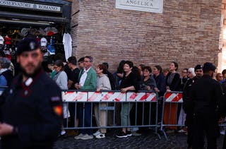 People queue to enter St Peter's Square on Thursday morning