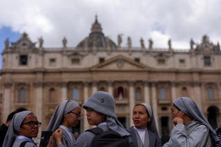 Nuns wait at St Peter's Square on the second day of the conclave