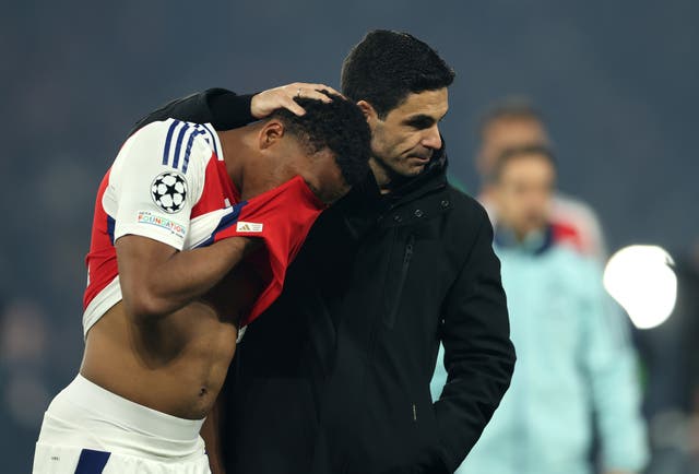 <p>Jurrien Timber of Arsenal is consoled by Mikel Arteta after defeat to PSG</p>
