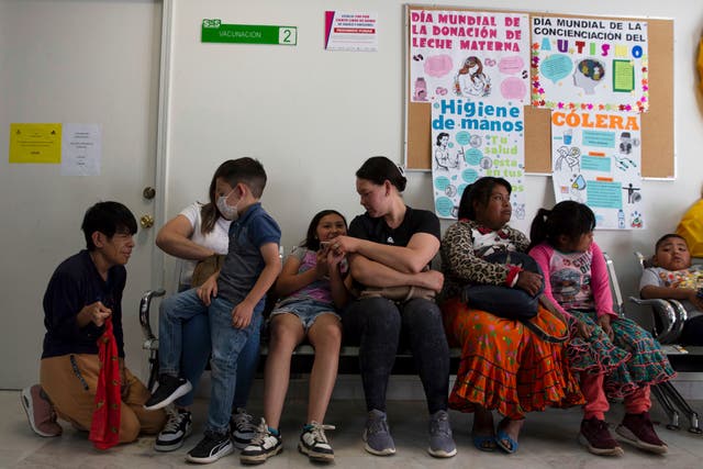 <p>People wait to get vaccinated for measles at a health center in Cuauhtemoc, Chihuahua state, Mexico</p>