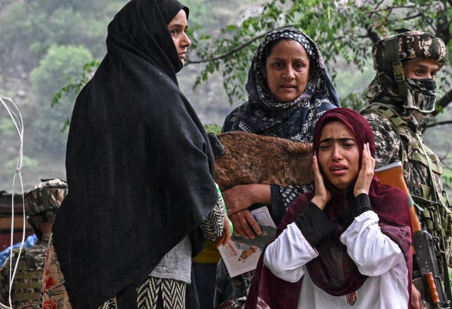 <p>Indian villagers react while waiting for transportation as they evacuate following overnight Pakistani artillery shelling in Uri</p>