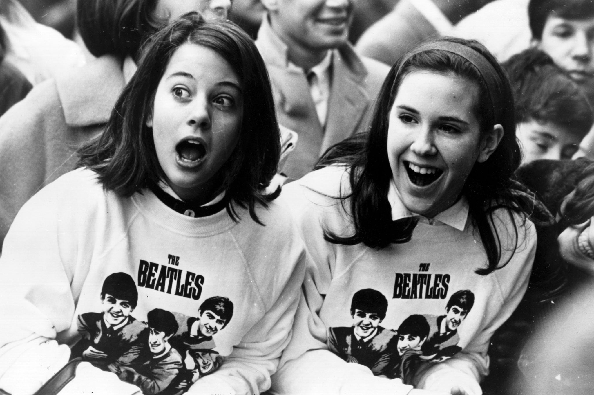The popular depiction of Beatlemania: two girls in Beatles sweatshirts wait for the band's arrival in New York in 1964