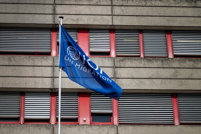 <p>This photograph shows a flag waving at the headquarters of the International Organization for Migration (IOM) in Geneva on March 13, 2025</p>