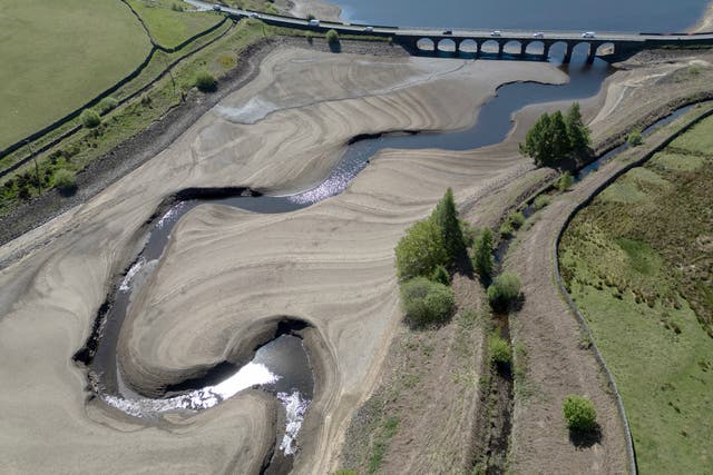 <p>An aerial photo shows the bed of Woodhead Reservoir is partially revealed by a falling water level, near Glossop, northern England on May 9, 2025</p>