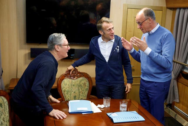 <p>Sir Keir Starmer, Emmanuel Macron and Friedrich Merz speak on a train to Kyiv </p>