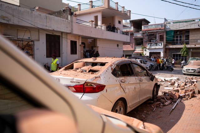 <p>Damage on vehicles seen next to the spot of an aerial attack from Pakistan that damaged a residential building on 10 May 2025, in Jammu, India</p>