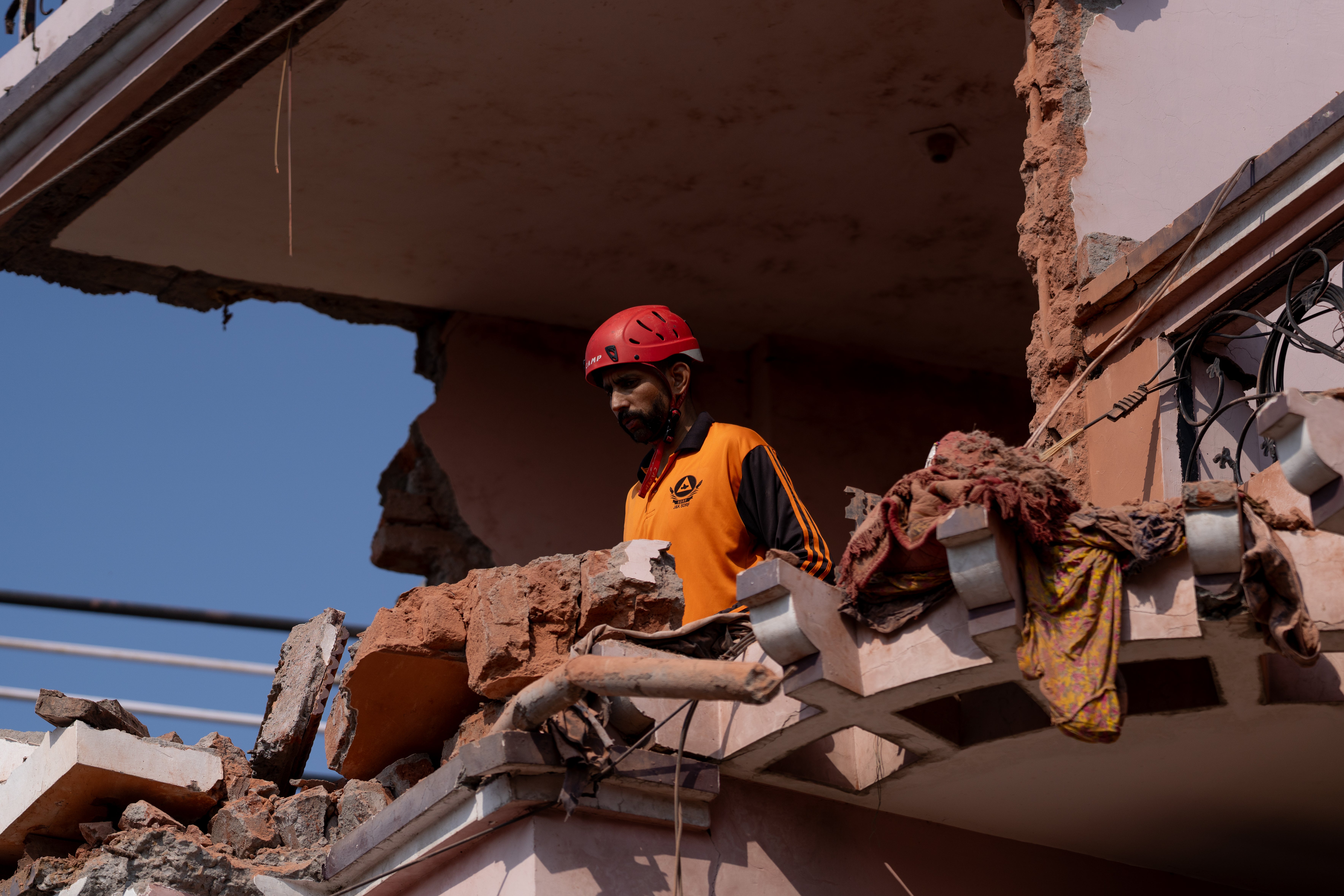 A rescue worker helps remove debris of a residential building that was damaged in an aerial attack from Pakistan in Jammu, India, on 10 May 2025