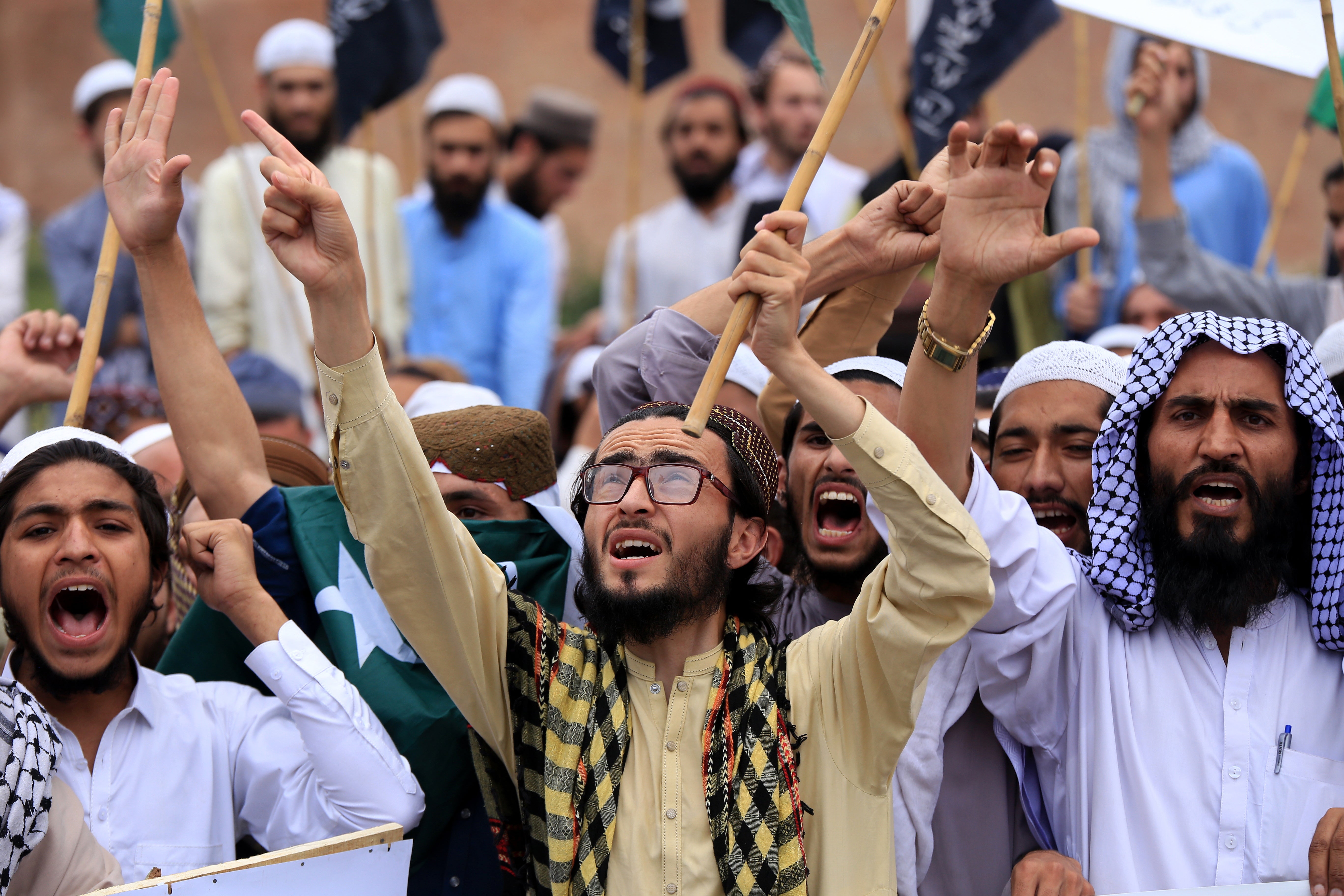 People hold national flags and placards, shouting anti-India slogans during a protest in front of the paramilitary FC headquarters, after India launched missile strikes in Pakistan, in Peshawar, Pakistan, 10 May 2025
