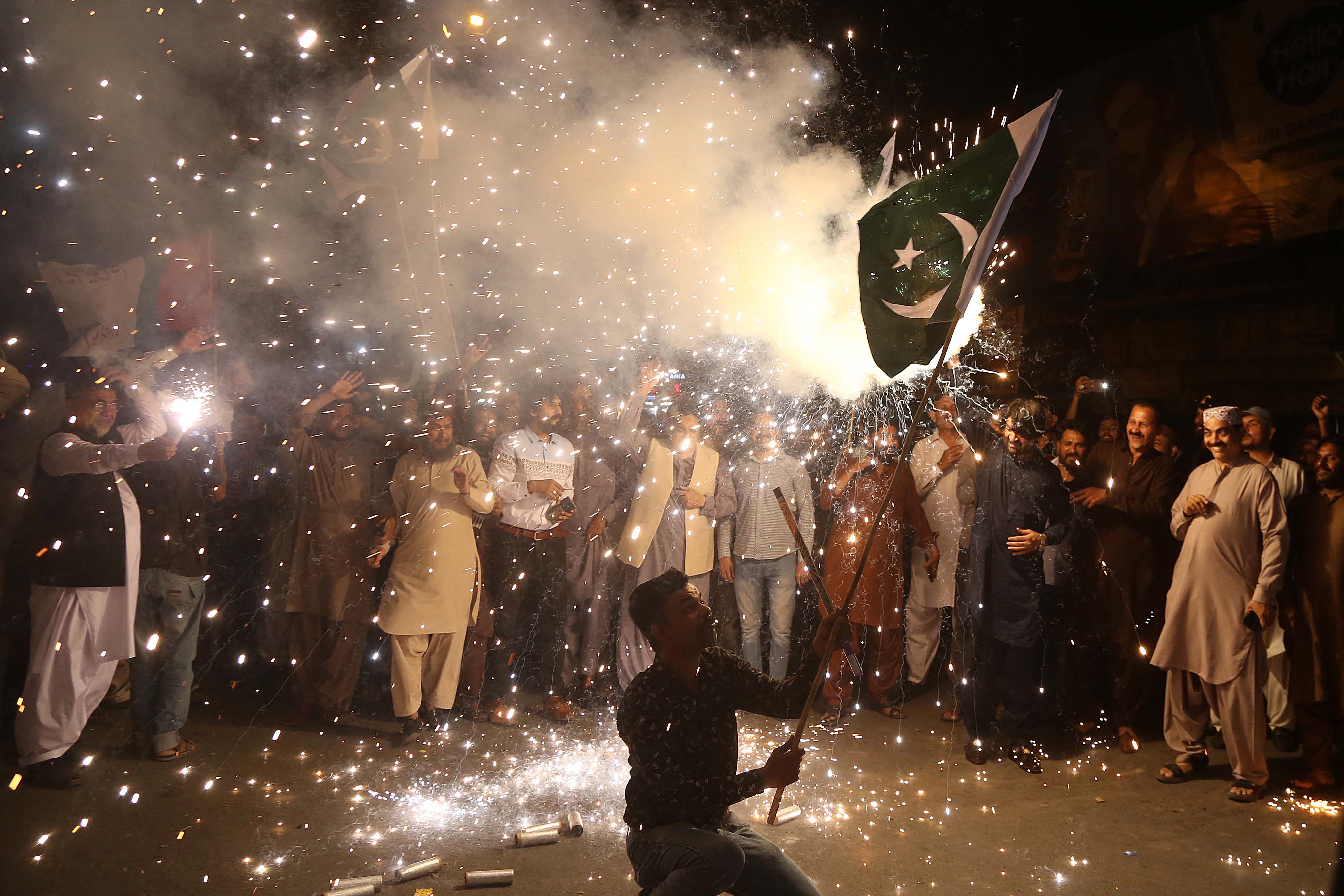 A man waves a Pakistani flag after a ceasefire was announced, but soon broken, earlier on Saturday