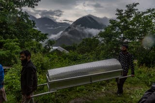 Kashmiri Muslims carry the bier after burying Nargis Begum, who was killed in artillery shelling allegedly carried out by Pakistani forces in the town of Uri