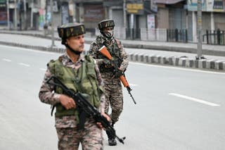 Indian paramilitary soldiers patrol at a marketplace in Srinagar on 10 May 2025