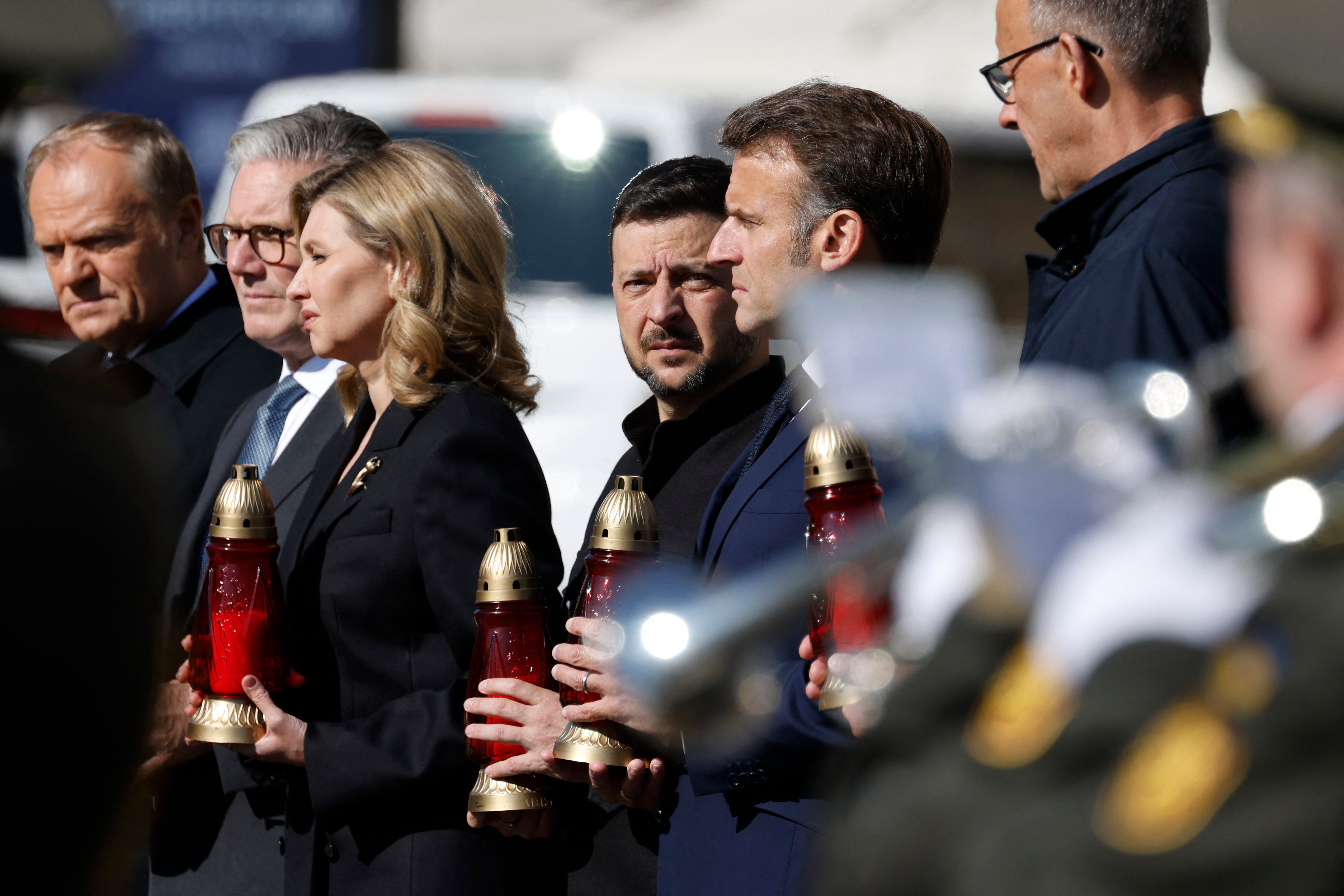 (From L) Poland's Prime Minister Donald Tusk, Britain's Prime Minister Keir Starmer, Olena Zelenska, Ukraine's President Volodymyr Zelensky, France's President Emmanuel Macron and Germany's Chancellor Friedrich Merz pay their respects to the victims of war at the Memorial for the Fallen at the Independence Square