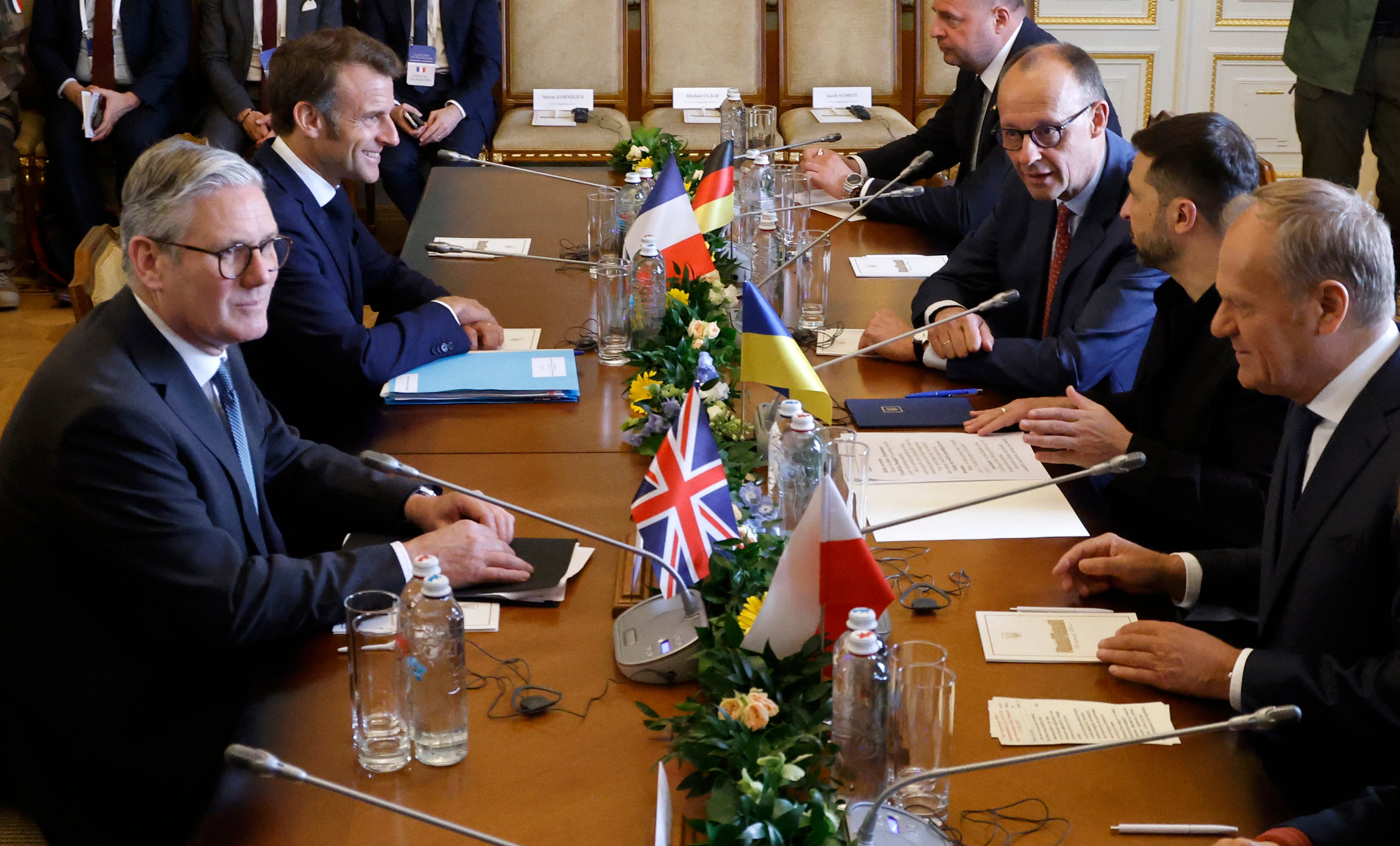 Ukraine's President Volodymyr Zelensky (2nd R) greets Britain's Prime Minister Keir Starmer (L), France's President Emmanuel Macron (2nd L), Poland's Prime Minister Donald Tusk (R) and Germany's Chancellor Friedrich Merz (3rd R) for a meeting at the Mariinskyi Palace, the official residence of the president of Ukraine, in Kyiv on May 10, 2025