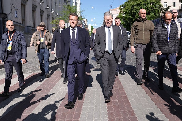 France's President Emmanuel Macron (L) and Britain's Prime Minister Keir Starmer (R) walks in a street of Kyiv on May 10, 2025.