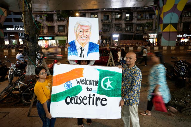 <p>Students of an art school and their teacher carry a hand-drawn portrait of the US President Donald Trump as they celebrate the ceasefire </p>