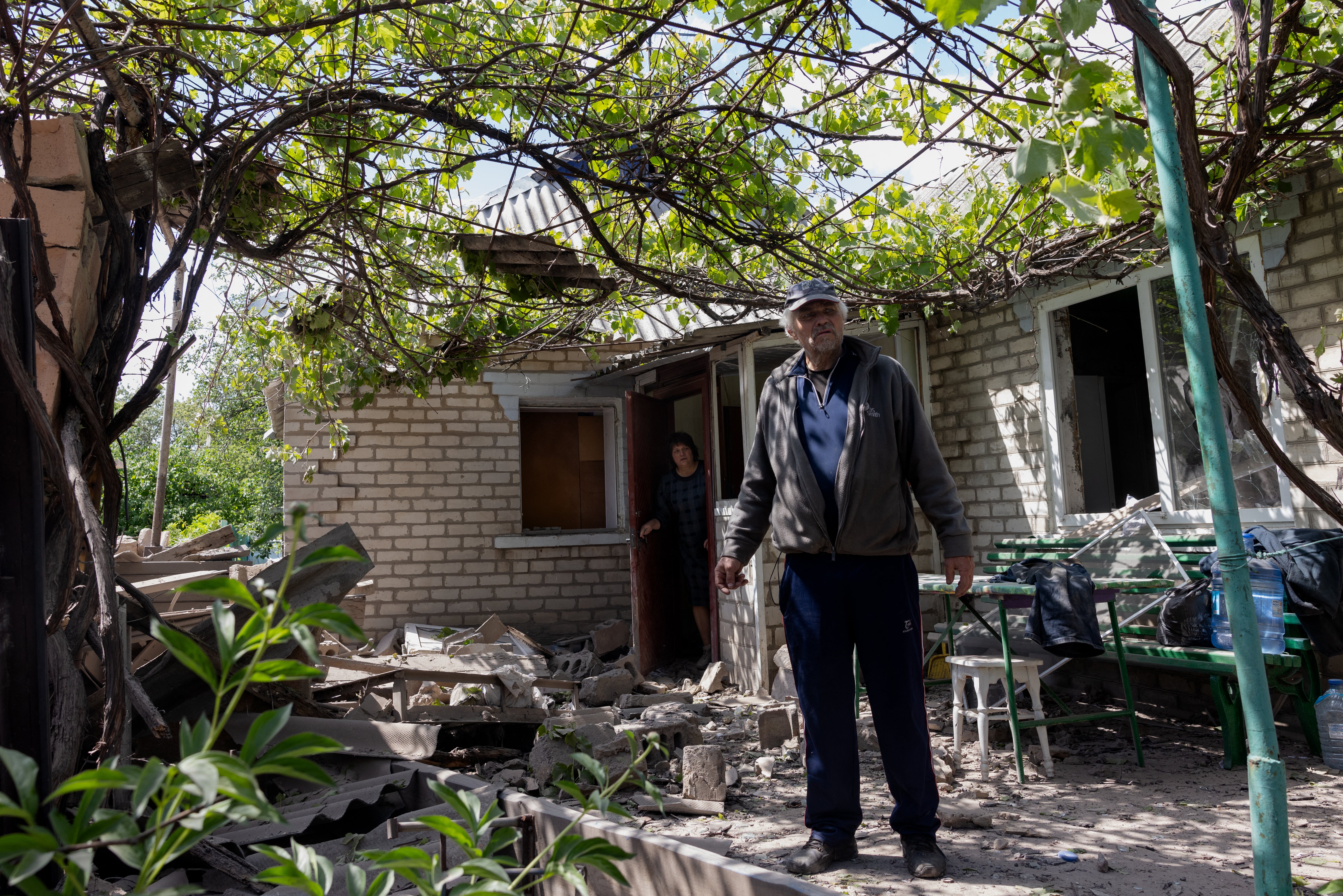 A local resident stands next a damaged private house after Russian shelling in Kramatorsk, Donetsk region on May 11, 2025, amid the Russian invasion of Ukraine.