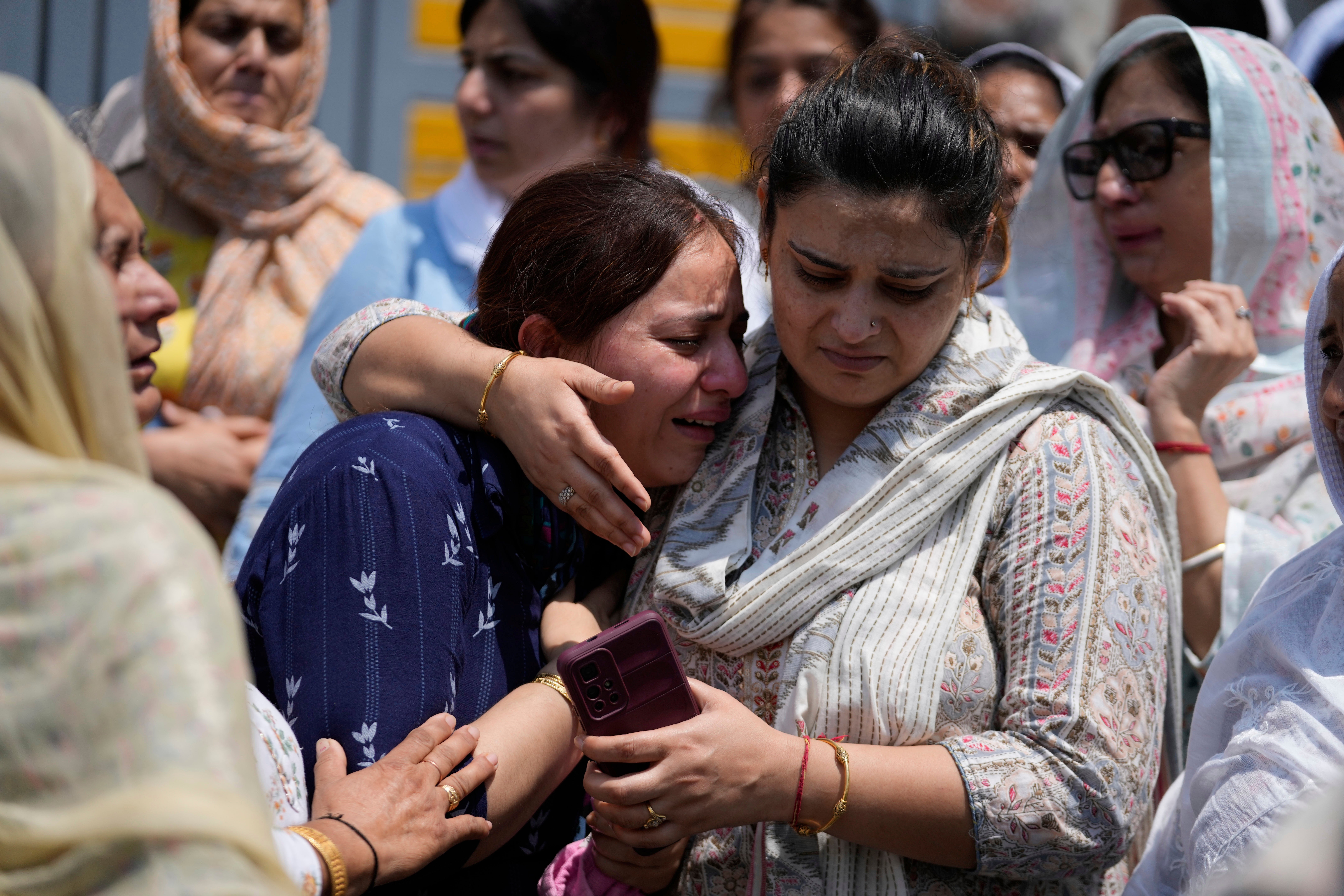 Relatives mourn at the funeral of Raj Thapa, a senior bureaucrat who was killed in Pakistani shelling in Rajouri, in Jammu, India