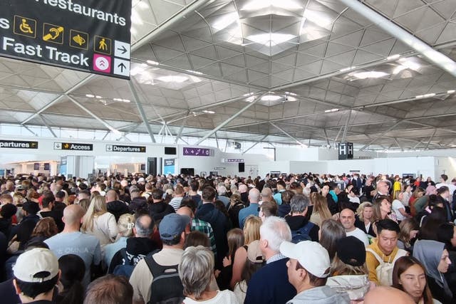 Passengers at Stansted Airport (Jonathan Goodacre/PA)