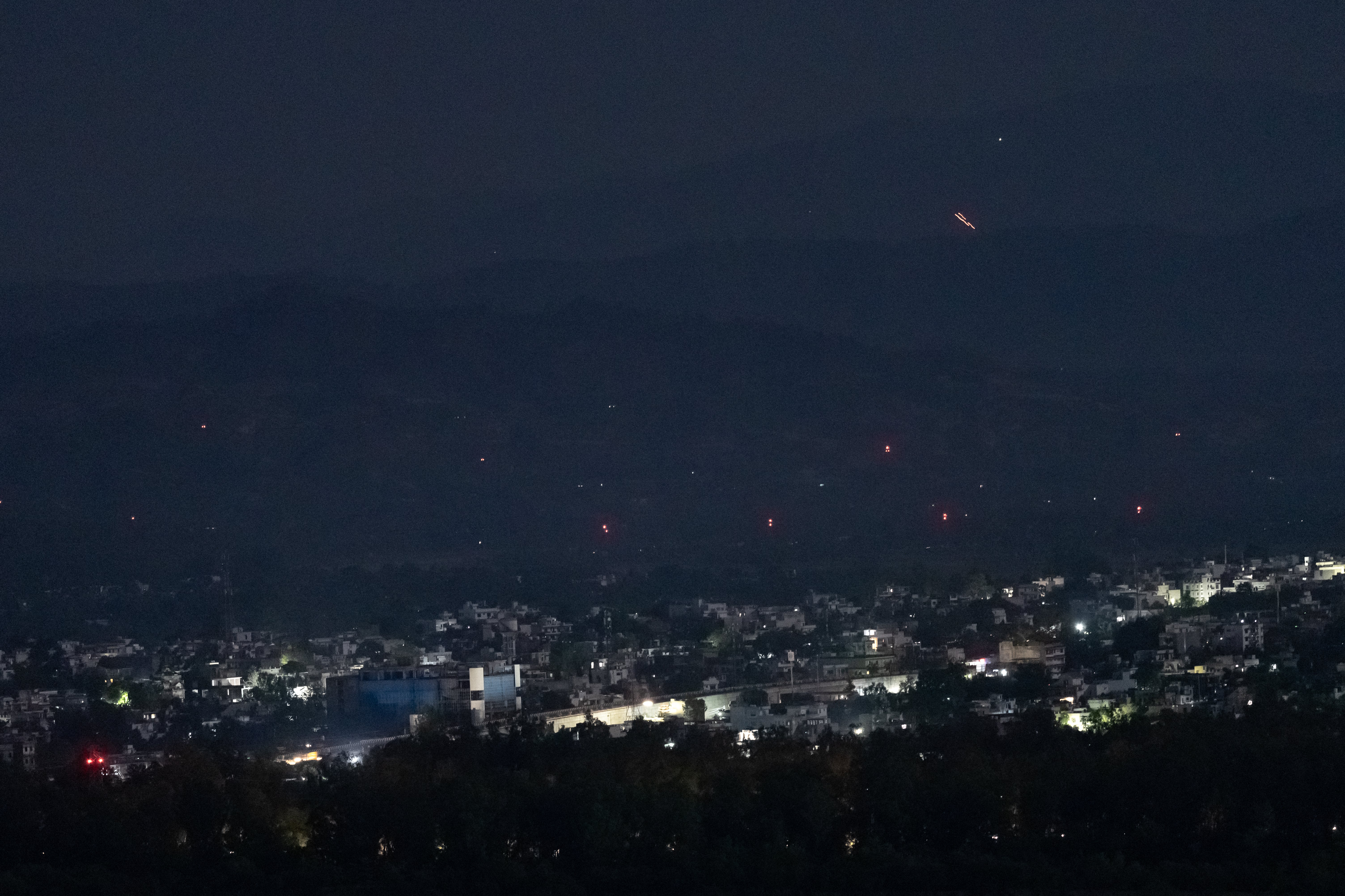 Streaks of light illuminate the sky as Indian air defence systems engage hostile objects on 10 May 2025 in Jammu, India