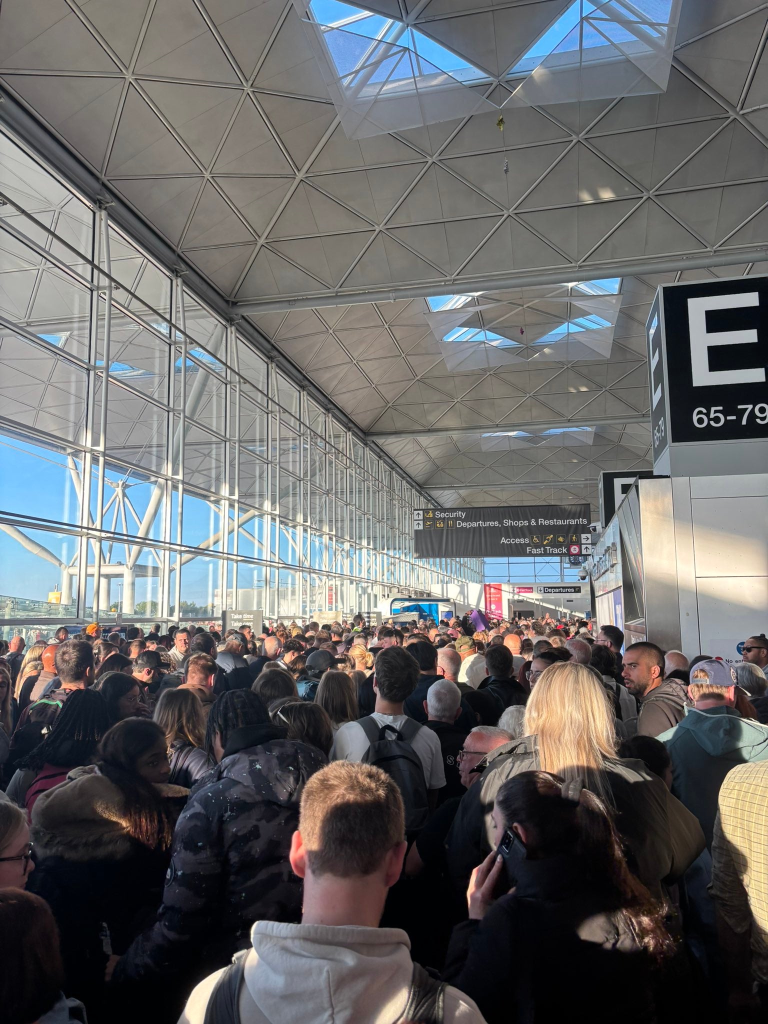 Waiting game: passengers queuing for check-in and security at London Stansted airport on 11 May 2025