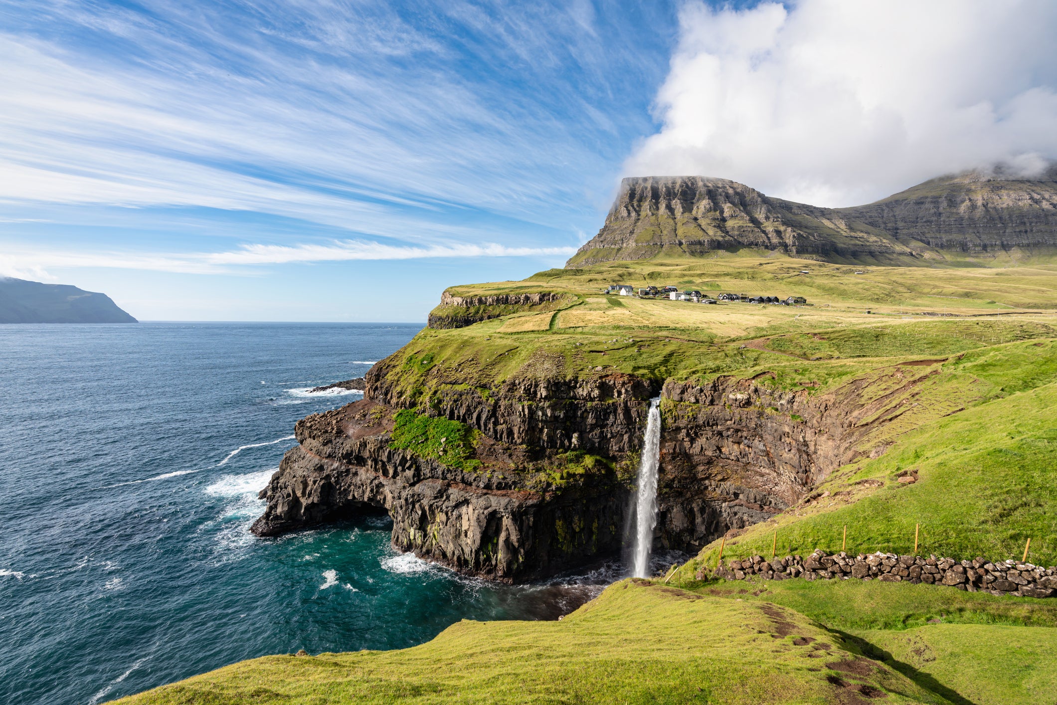 Mulafossur waterfall cascades directly into the Atlantic
