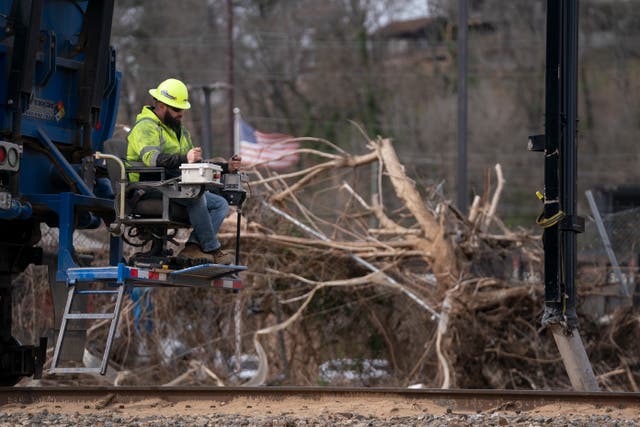 <p>A worker attends to a western North Carolina rail road amid debris from Hurricane Helene. The area is set to see the first ‘noteworthy flooding threat’ since September this week</p>