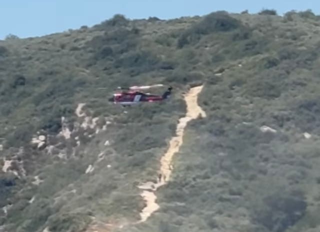 <p>An Orange County firefighting helicopter works to rescue stranded hikers in Aliso and Wood Canyons Wilderness Park</p>