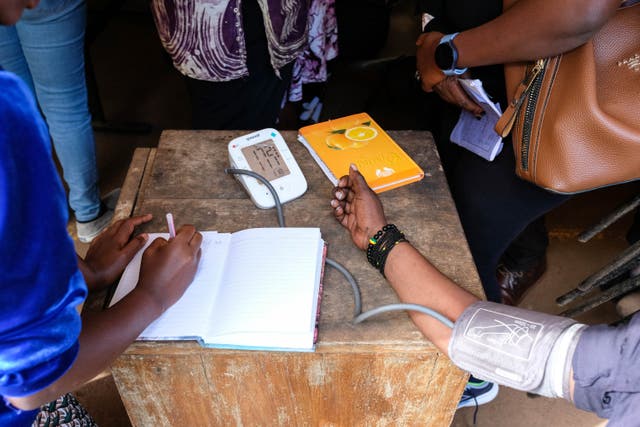 <p>Medical team takes patient's blood pressure</p>