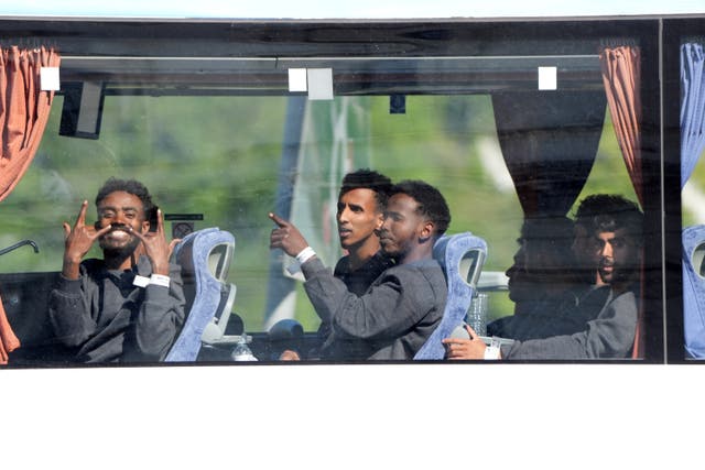 <p>Migrants who have crossed the English Channel leave Dover in a bus</p>