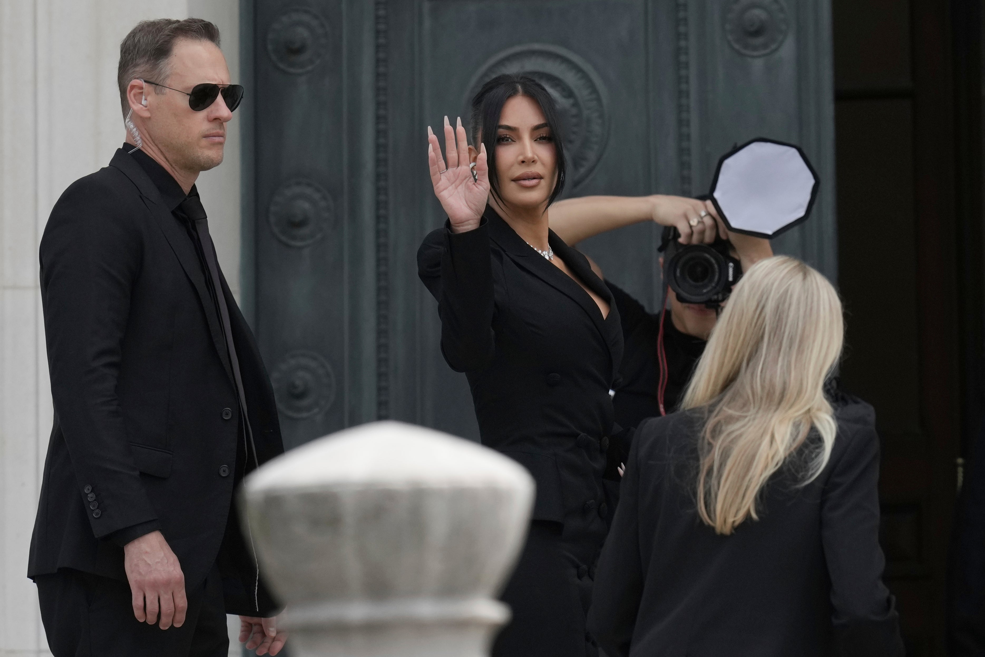 Kardashian waves as she enters court