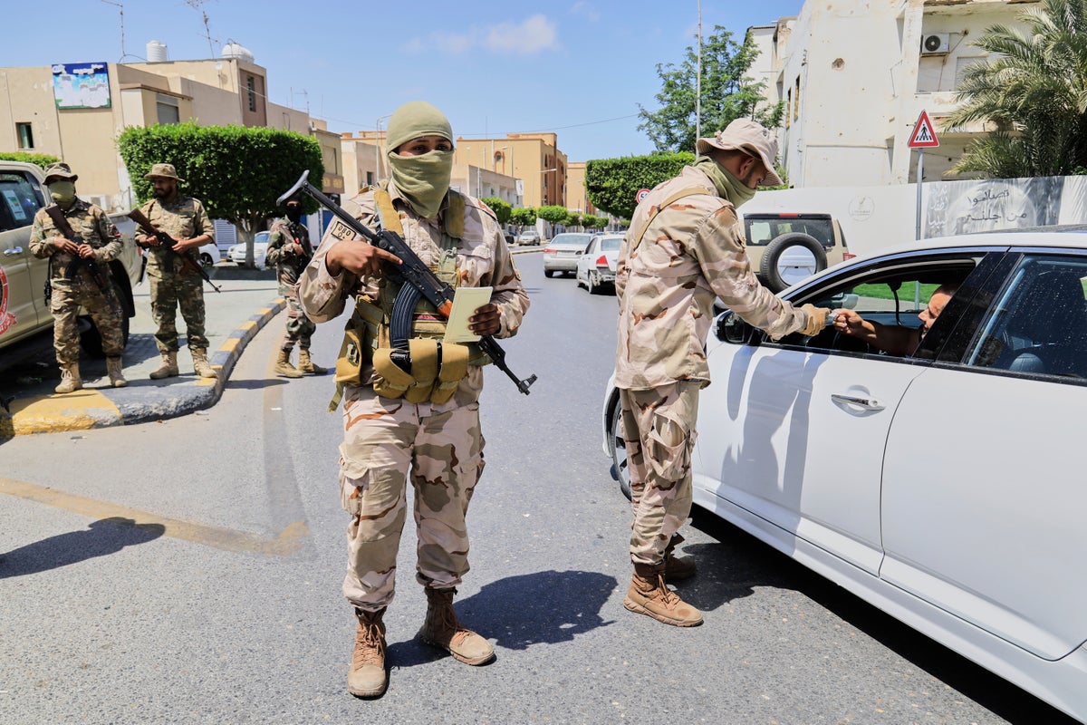 A warlord and 6 other people killed as militia infighting rocks Libya's capital, officials say