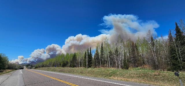 <p>Scene shows rising smoke from the Camp House Fire in Brimson, Minnesota, about 44 miles northeast of Duluth. The blaze was 1,250 acres by Monday, and actively burning</p>