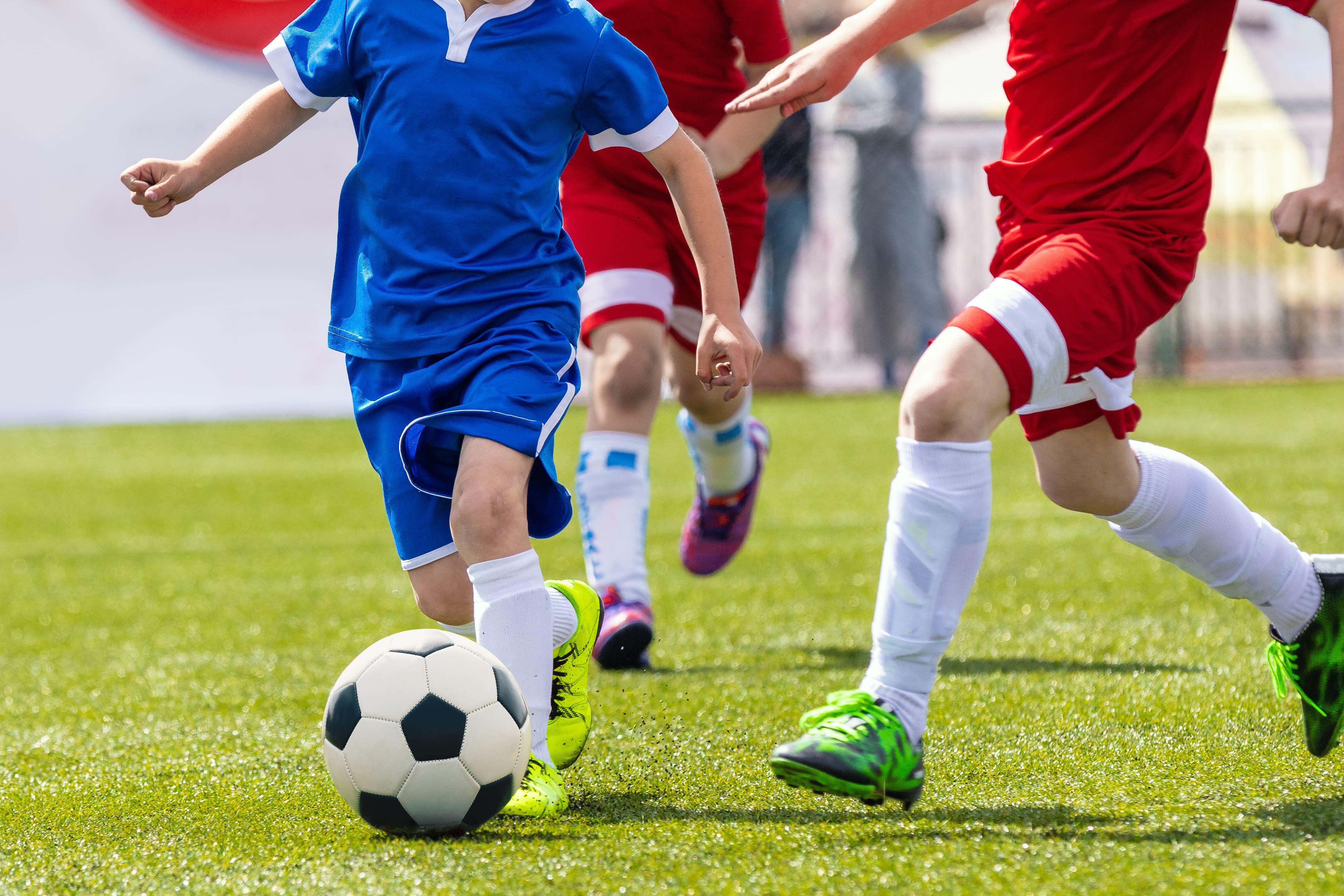 Playing organised spots in childhood appears to help prevent mental ill health in adolescence (Alamy/PA)
