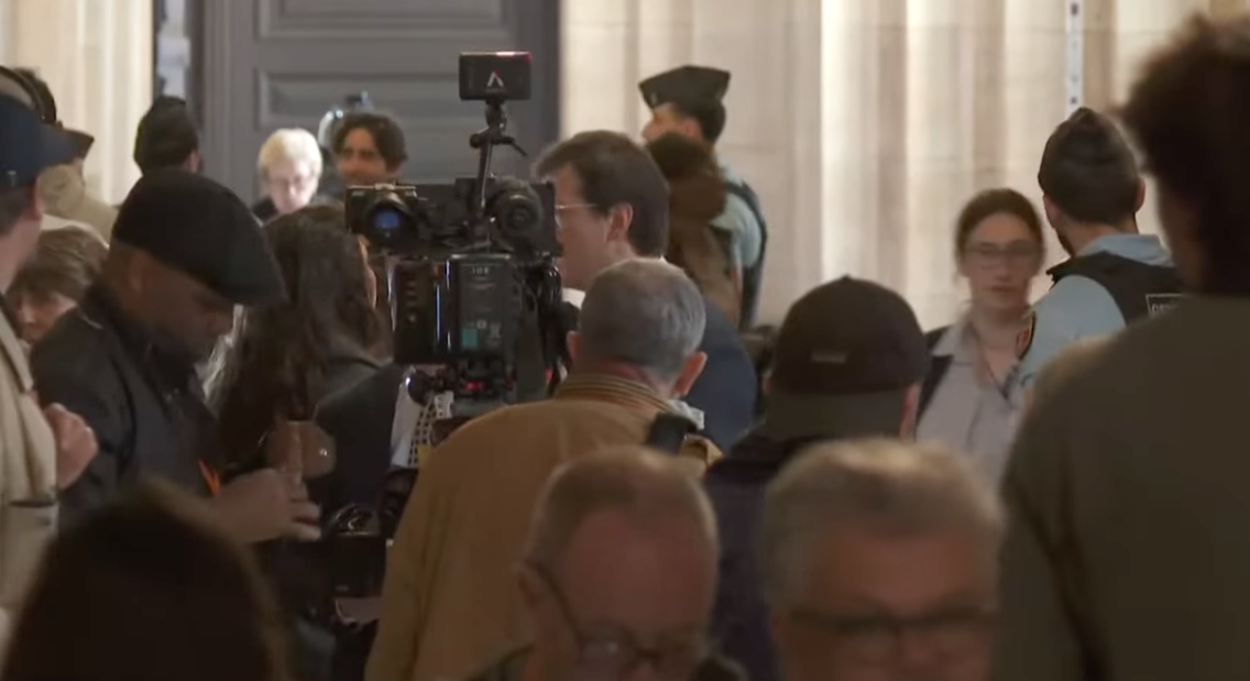 Dozens of media representatives are queueing up outside the court