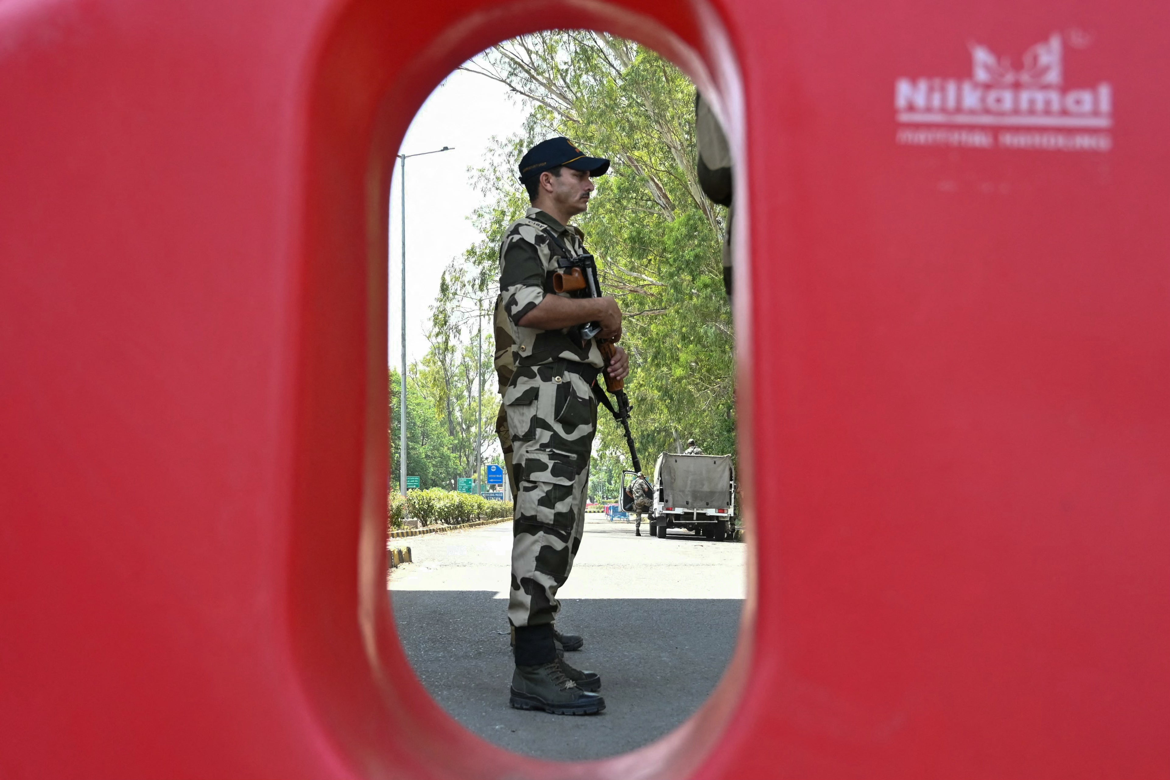 Indian Central Industrial Security Forces (CISF) personnel stand guards at the entrance road of the Shri Guru Ram Das Ji International Airport on the outskirts of Amritsar on 12 May 2025