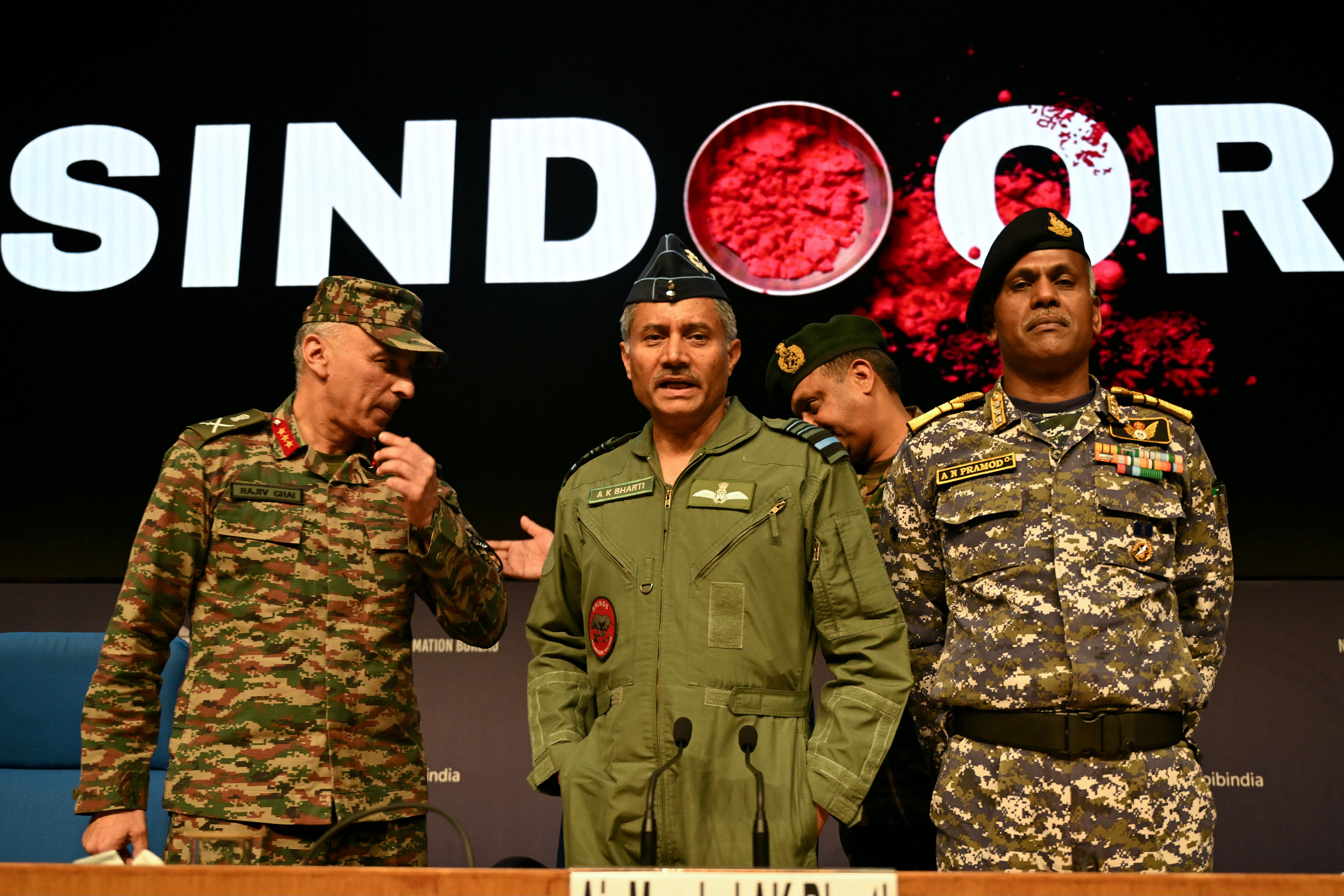Indian Army Director General of Military Operations Lt Gen Rajiv Ghai (L), Indian Airforce Air Marshal AK Bharti (C), Indian Navy Vice Admiral AN Pramod (R) gestures after a press conference in New Delhi, on 12 May 2025