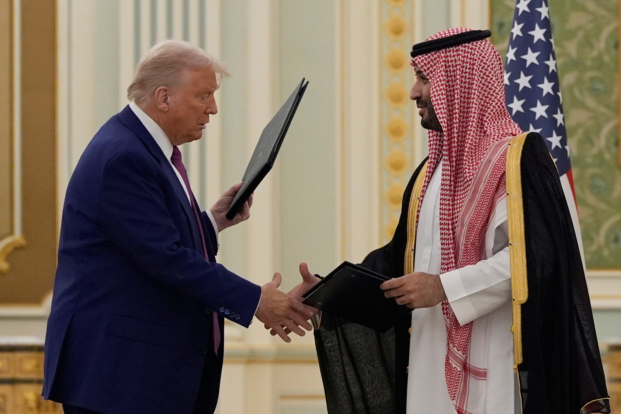 President Donald Trump and Saudi Crown Prince Mohammed bin Salman shake hands after exchanging documents during a signing ceremony at the Royal Palace in Riyadh, Saudi Arabia, Tuesday, 13 May 2025