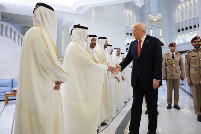 <p>Donald Trump shakes hands with officials in Doha</p>